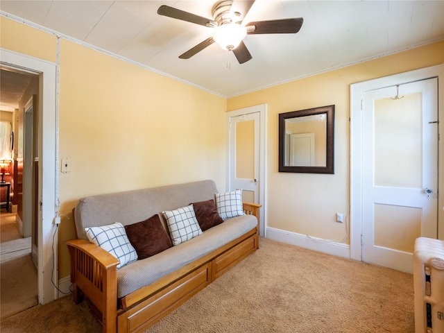 679 Saint Lukes Pl, Baldwin, NY 11510 - living area with light carpet, a ceiling fan, radiator heating unit, ornamental molding, and baseboards