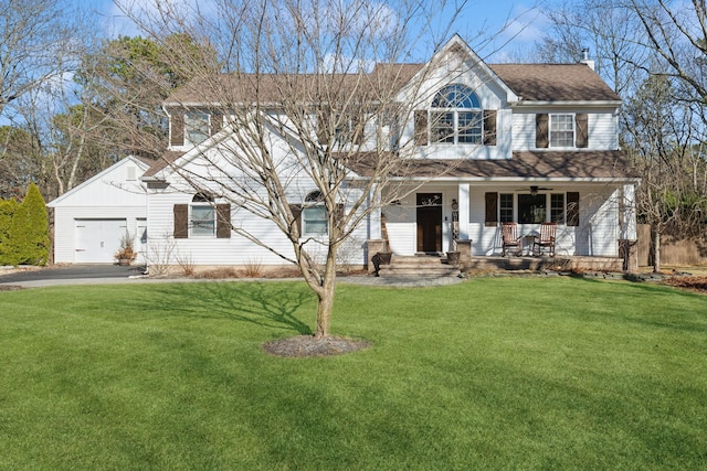 view of front of home featuring aphalt driveway, a front yard, roof with shingles, covered porch, and an attached garage