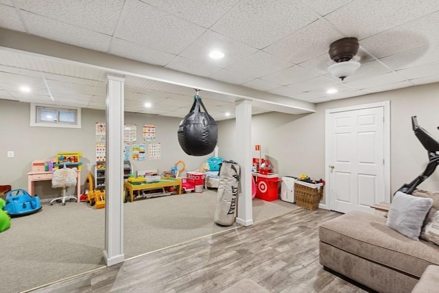 rec room with recessed lighting, a paneled ceiling, and wood finished floors