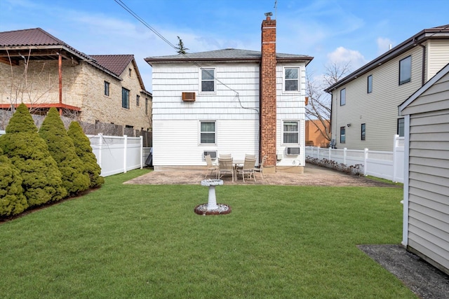 back of property with a yard, a fenced backyard, a chimney, and a patio area