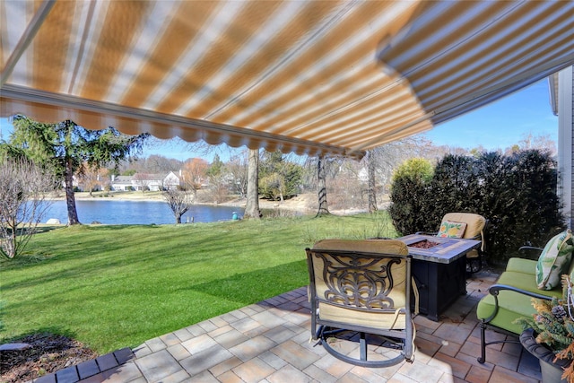 view of patio featuring a water view and an outdoor fire pit