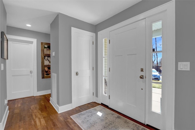 foyer with recessed lighting, baseboards, and dark wood-style flooring