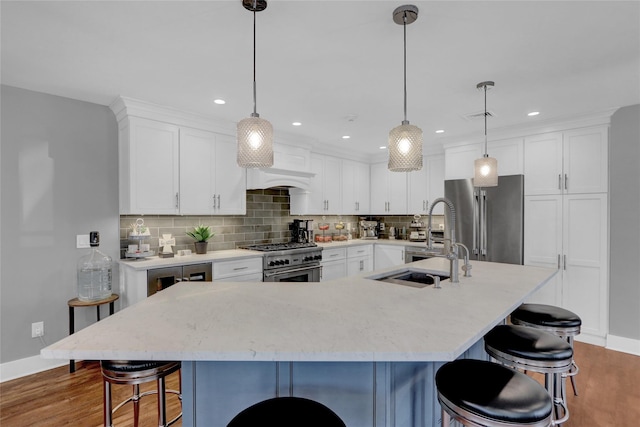 kitchen featuring tasteful backsplash, premium appliances, and wood finished floors