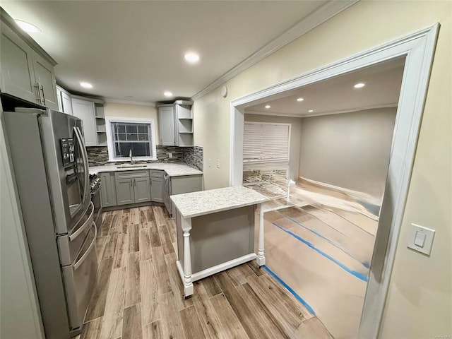 kitchen with open shelves, freestanding refrigerator, decorative backsplash, light wood-style floors, and crown molding