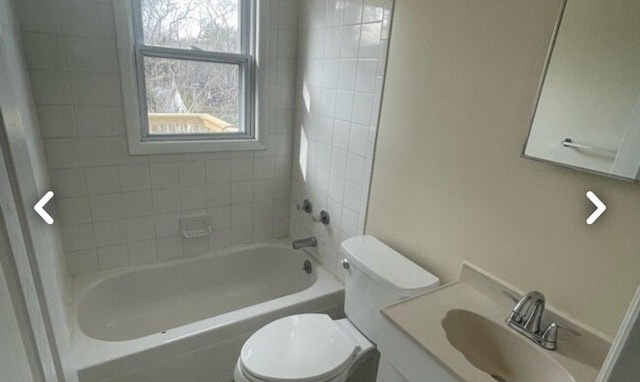 bathroom with toilet, shower / washtub combination, and vanity