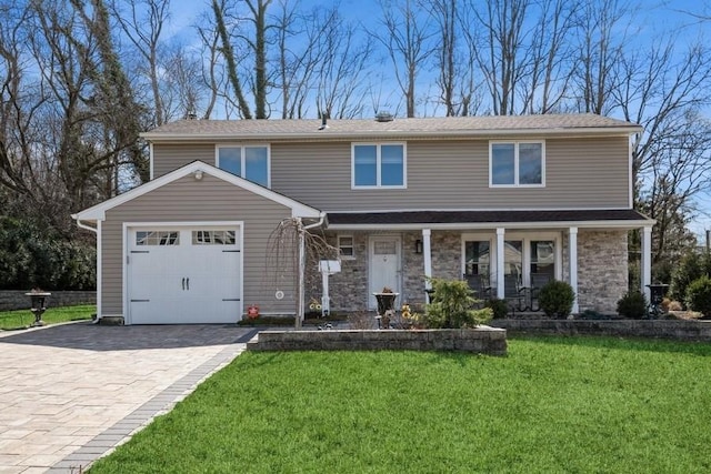 view of front of property with a front lawn, decorative driveway, stone siding, a porch, and a garage