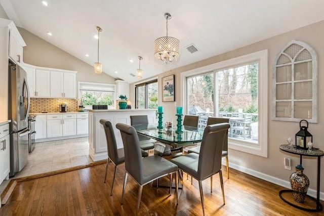 dining room featuring lofted ceiling, light wood-style flooring, recessed lighting, and visible vents