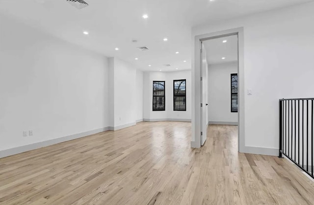 spare room with recessed lighting, visible vents, light wood finished floors, and baseboards