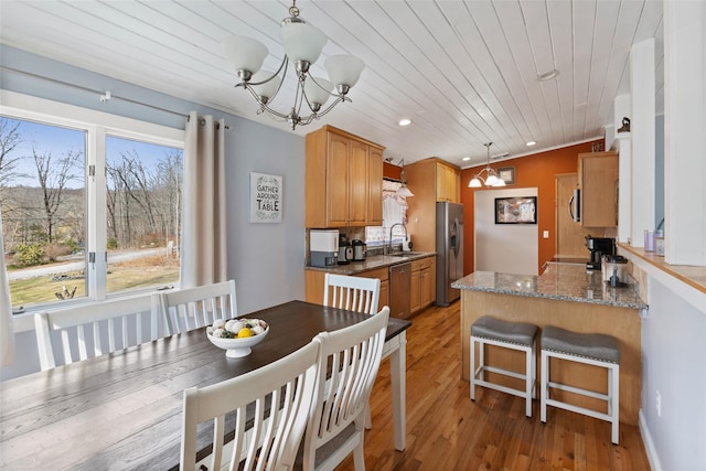 dining space featuring recessed lighting, light wood-style floors, an inviting chandelier, wooden ceiling, and lofted ceiling