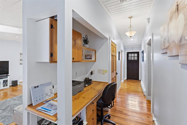 office with light wood finished floors, visible vents, and baseboards