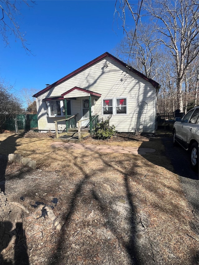 back of house featuring driveway