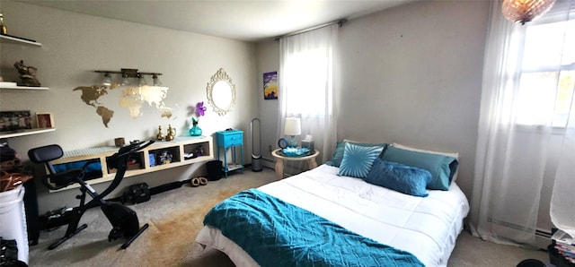 bedroom featuring baseboard heating and carpet flooring