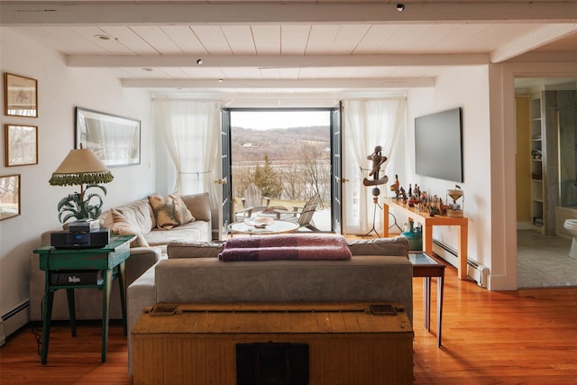 living area featuring beam ceiling, baseboard heating, and wood finished floors