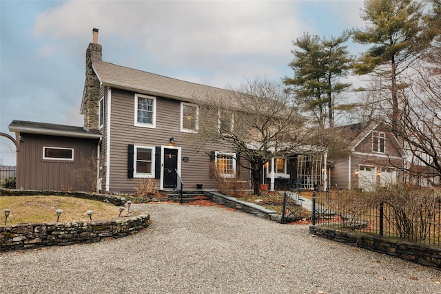 view of front of home with fence and a chimney