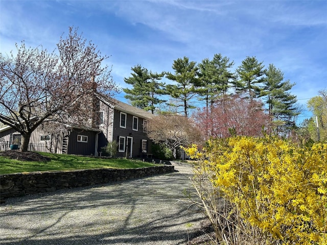 26 Curry Ln, Hyde Park, NY 12538 - exterior space with a front yard and board and batten siding