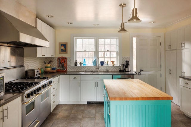26 Curry Ln, Hyde Park, NY 12538 - kitchen featuring wood counters, double oven range, a sink, wall chimney exhaust hood, and backsplash