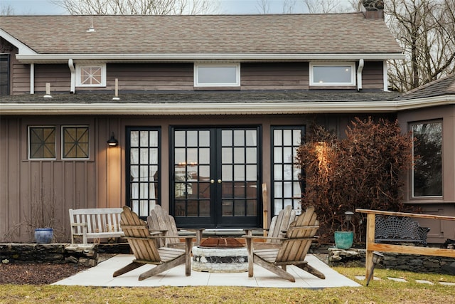 26 Curry Ln, Hyde Park, NY 12538 - view of exterior entry with a chimney, french doors, and a shingled roof