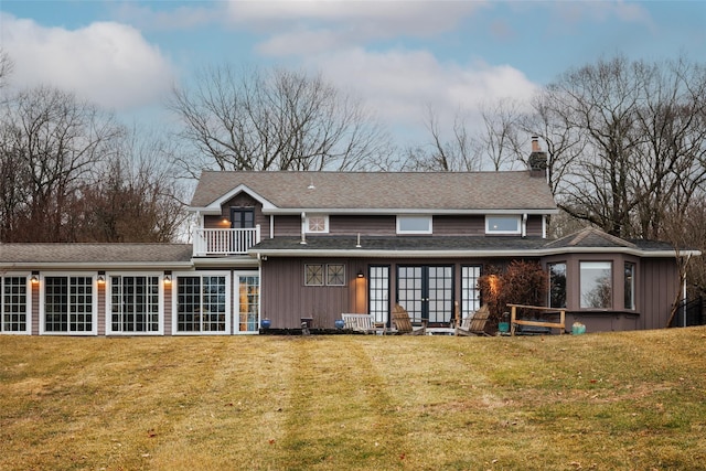 26 Curry Ln, Hyde Park, NY 12538 - rear view of property with a yard, a chimney, board and batten siding, and a balcony