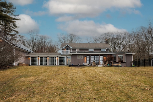 26 Curry Ln, Hyde Park, NY 12538 - rear view of property featuring a chimney, french doors, board and batten siding, and a lawn