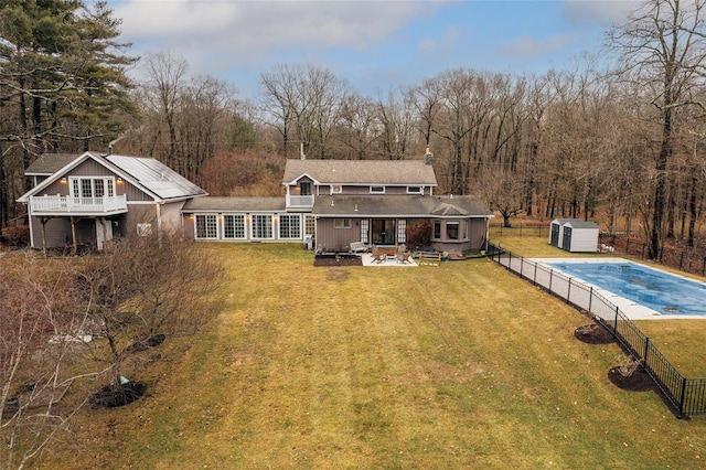 26 Curry Ln, Hyde Park, NY 12538 - back of property featuring fence, an outbuilding, a fenced in pool, a storage shed, and a lawn