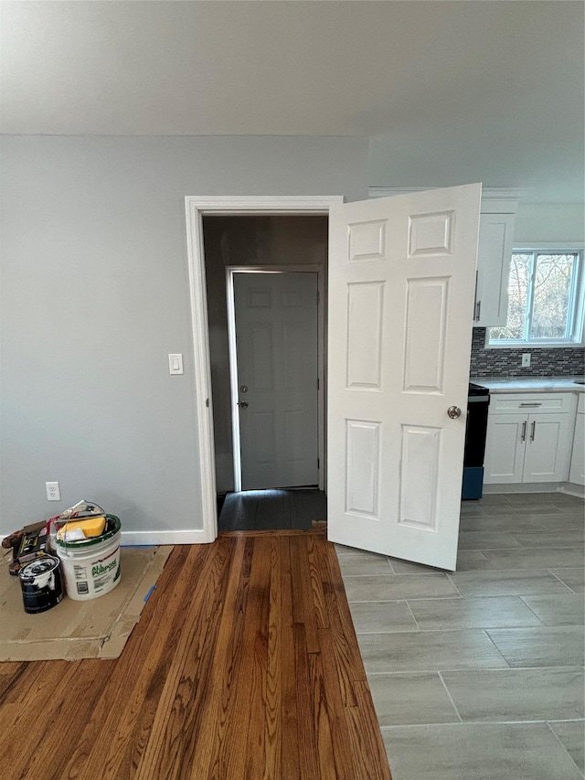 interior space with baseboards and light wood-type flooring