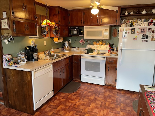 kitchen featuring ceiling fan, white appliances, light countertops, and a sink