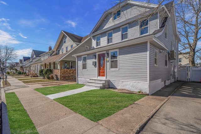 view of front facade with a residential view, entry steps, and a front lawn