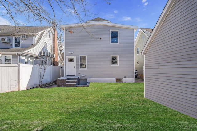 back of house featuring a yard and fence