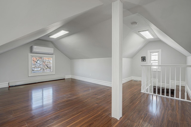 bonus room with baseboards, an AC wall unit, vaulted ceiling, baseboard heating, and wood finished floors