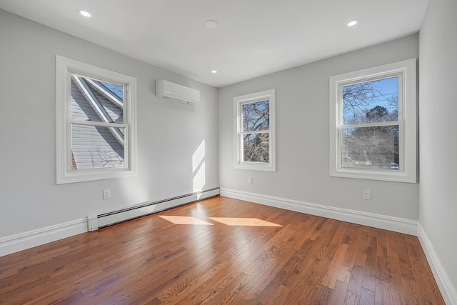 unfurnished room featuring baseboards, a baseboard radiator, wood-type flooring, and a wall mounted AC