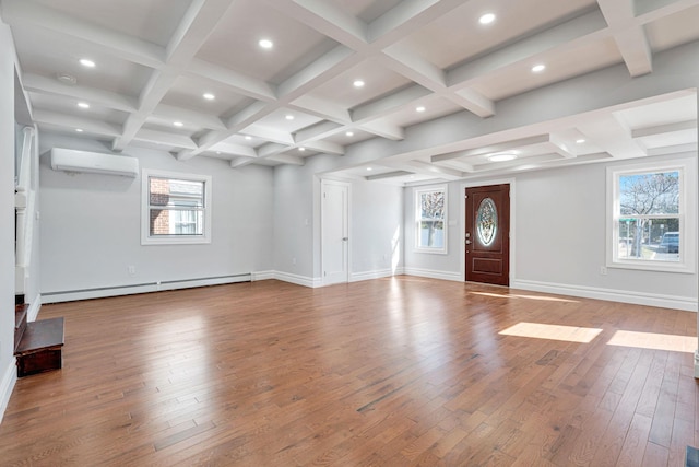 unfurnished living room with beamed ceiling, an AC wall unit, hardwood / wood-style floors, coffered ceiling, and a baseboard radiator