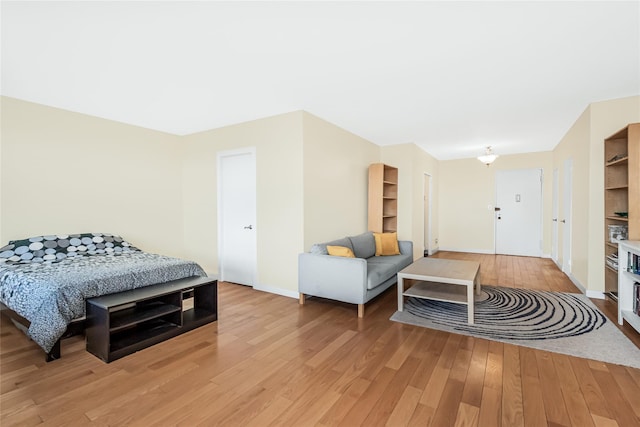 bedroom featuring baseboards and light wood-type flooring