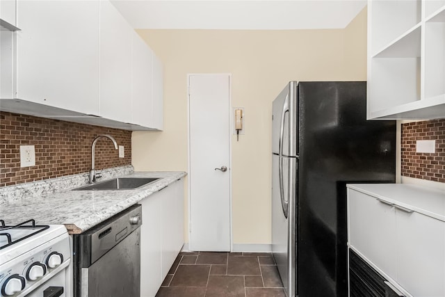 kitchen featuring open shelves, a sink, white cabinets, appliances with stainless steel finishes, and backsplash