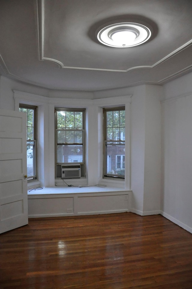 empty room with plenty of natural light, baseboards, and wood finished floors