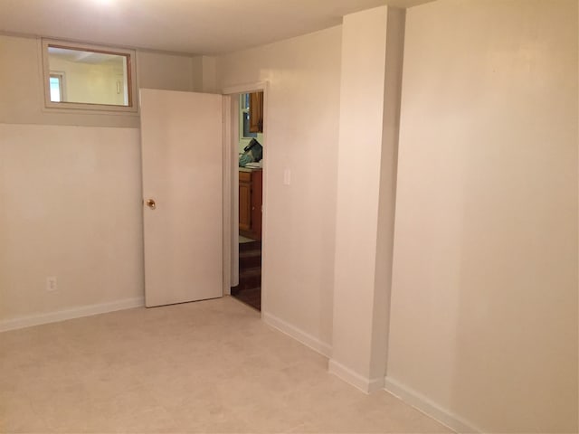 spare room featuring baseboards