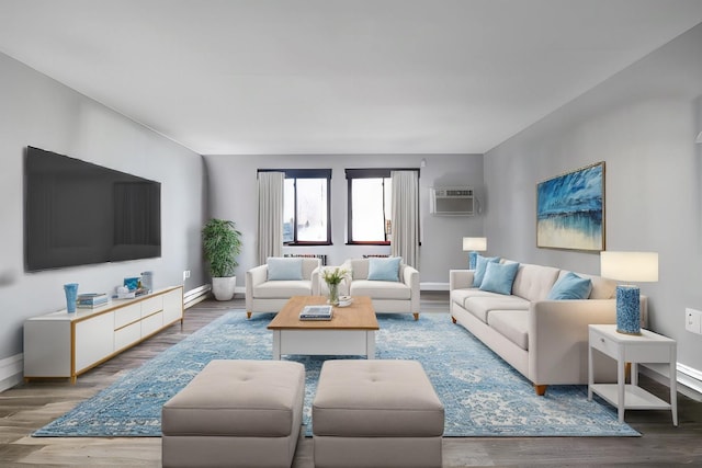 living room featuring baseboards, an AC wall unit, and wood finished floors