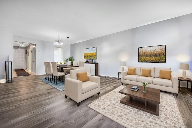 living room with a notable chandelier and wood finished floors