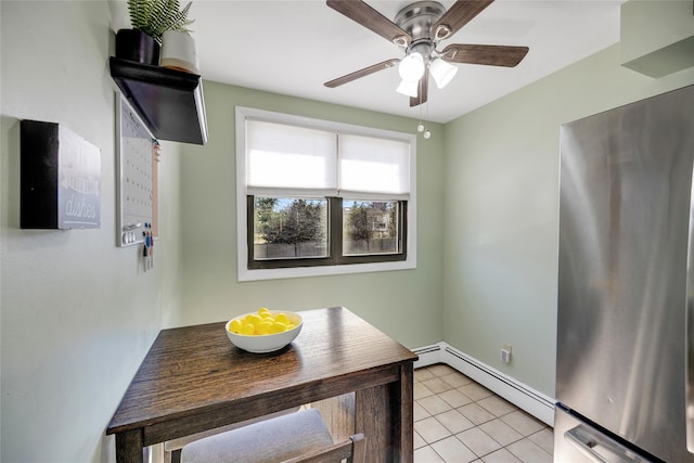 dining area with light tile patterned floors, baseboard heating, and a ceiling fan