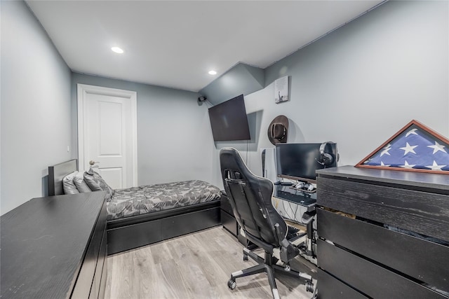 bedroom with recessed lighting and wood finished floors