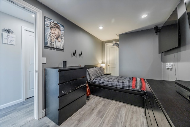 bedroom with recessed lighting, light wood-style floors, and baseboards