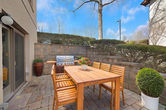 view of patio with area for grilling and outdoor dining space