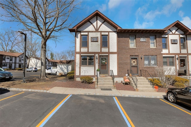 view of property with a residential view and uncovered parking