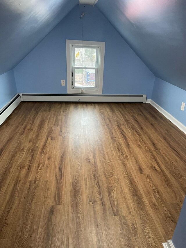 114-27 135th St, South Ozone Park, NY 11420 - bonus room with baseboard heating, wood finished floors, and vaulted ceiling