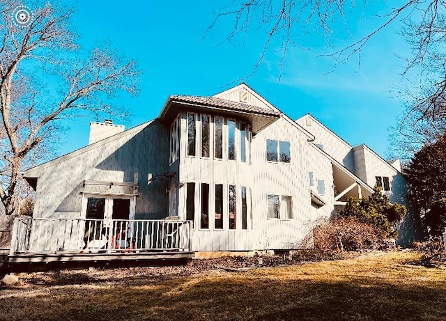 rear view of property featuring a chimney