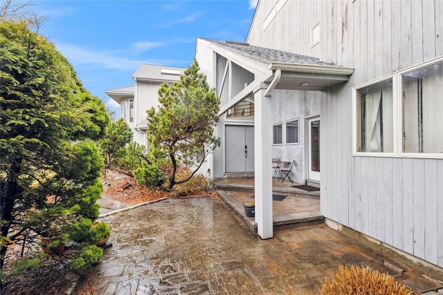 view of property exterior with a patio and a deck