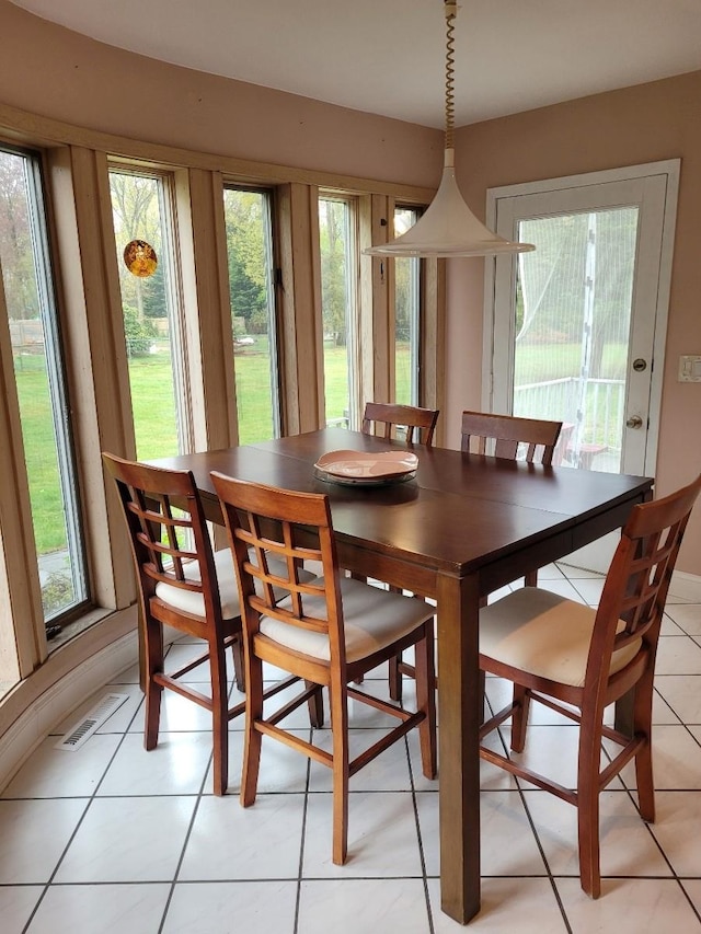 dining area featuring visible vents and light tile patterned floors