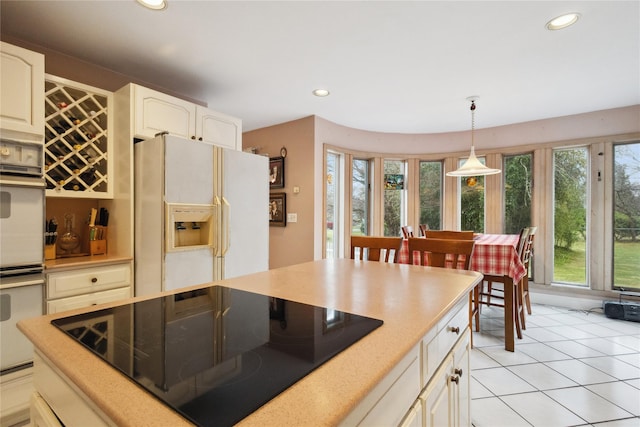 kitchen with white appliances, recessed lighting, and plenty of natural light