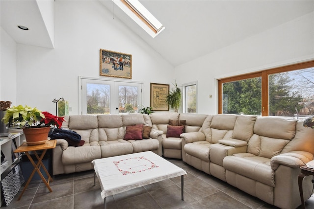 tiled living room with a skylight, high vaulted ceiling, and french doors