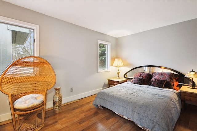 bedroom with wood finished floors and baseboards