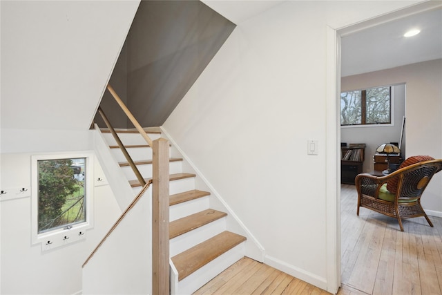 stairs with baseboards, hardwood / wood-style floors, and recessed lighting